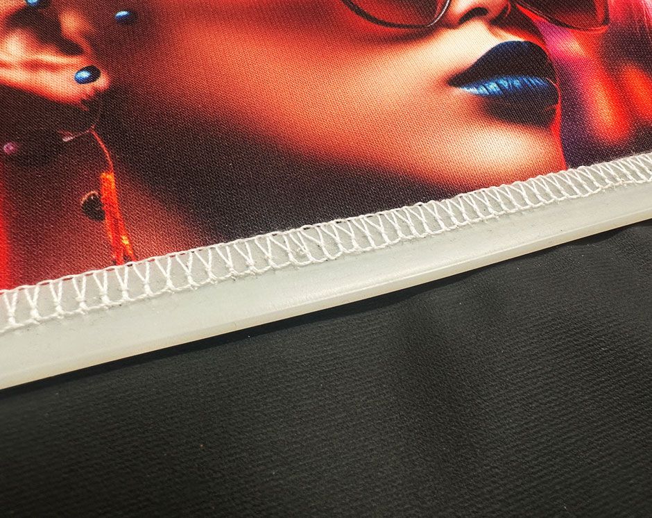 Close up of Silicon Edge stitched to fabric graphic with overlocked stitching